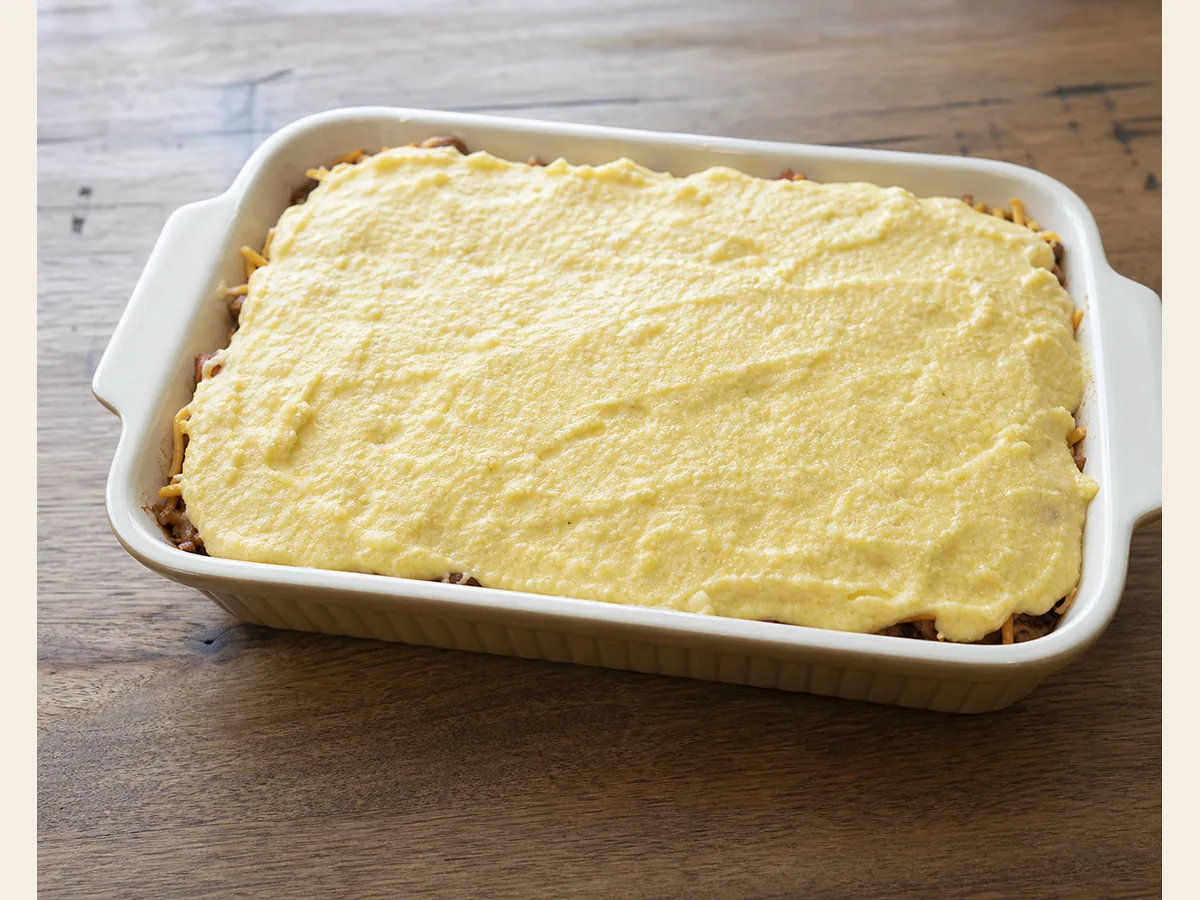 Cornbread batter gently spread over the cheddar-topped pulled pork filling before baking