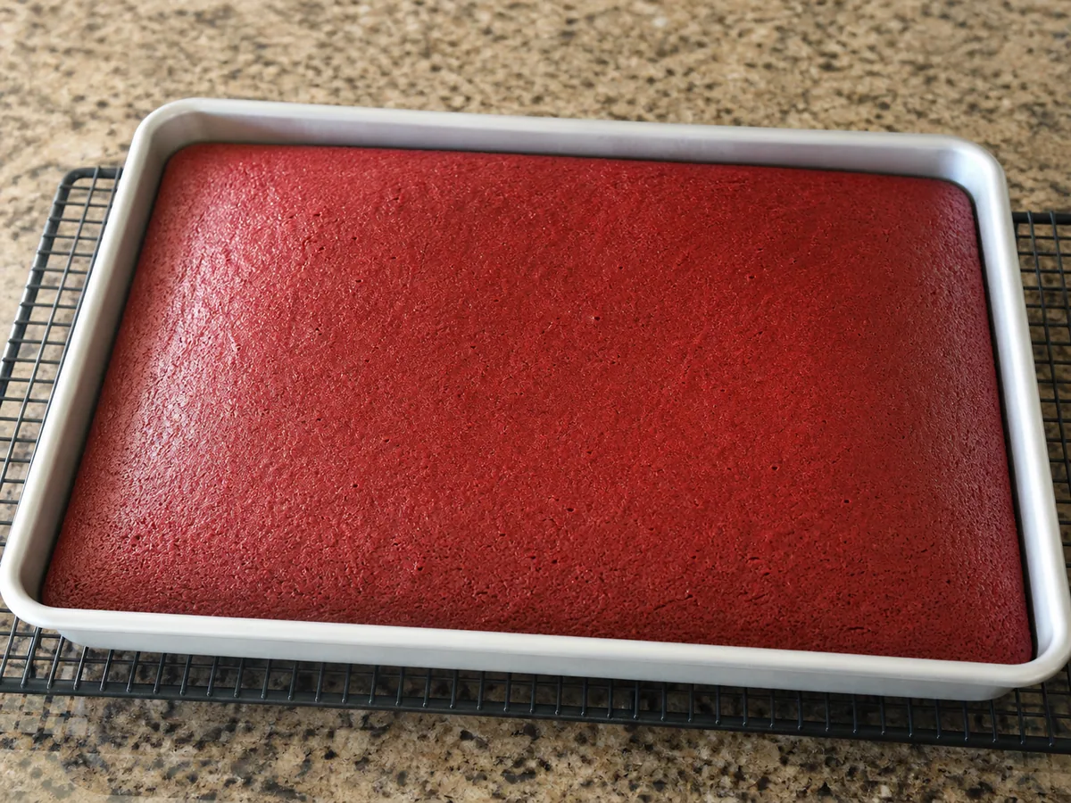 Fully baked American red velvet sheet cake showing a set springy surface