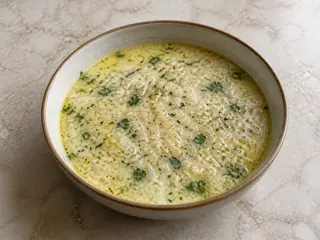 Bowl of Armenian spas yogurt and barley soup with cilantro and mint
