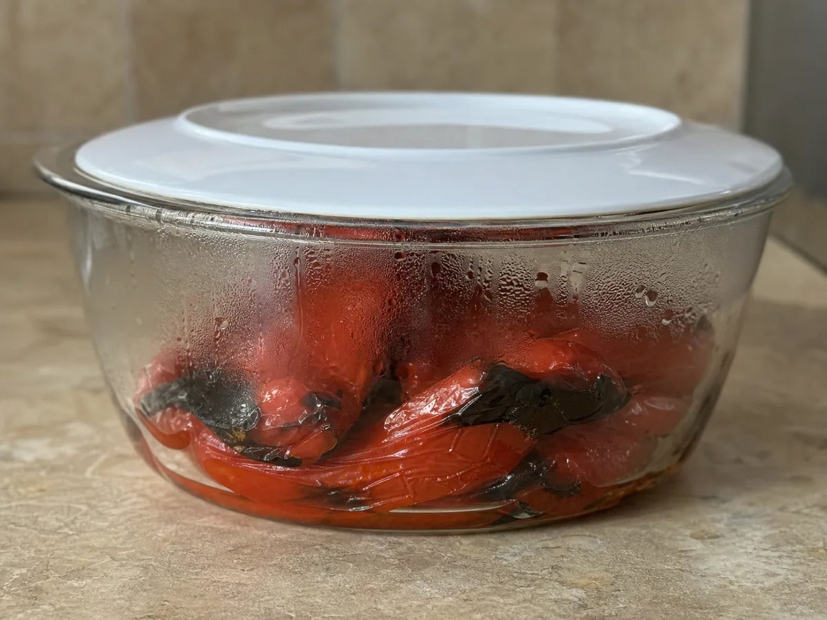 Peeled roasted red pepper halves in a heatproof bowl for Bosnian tarhana soup