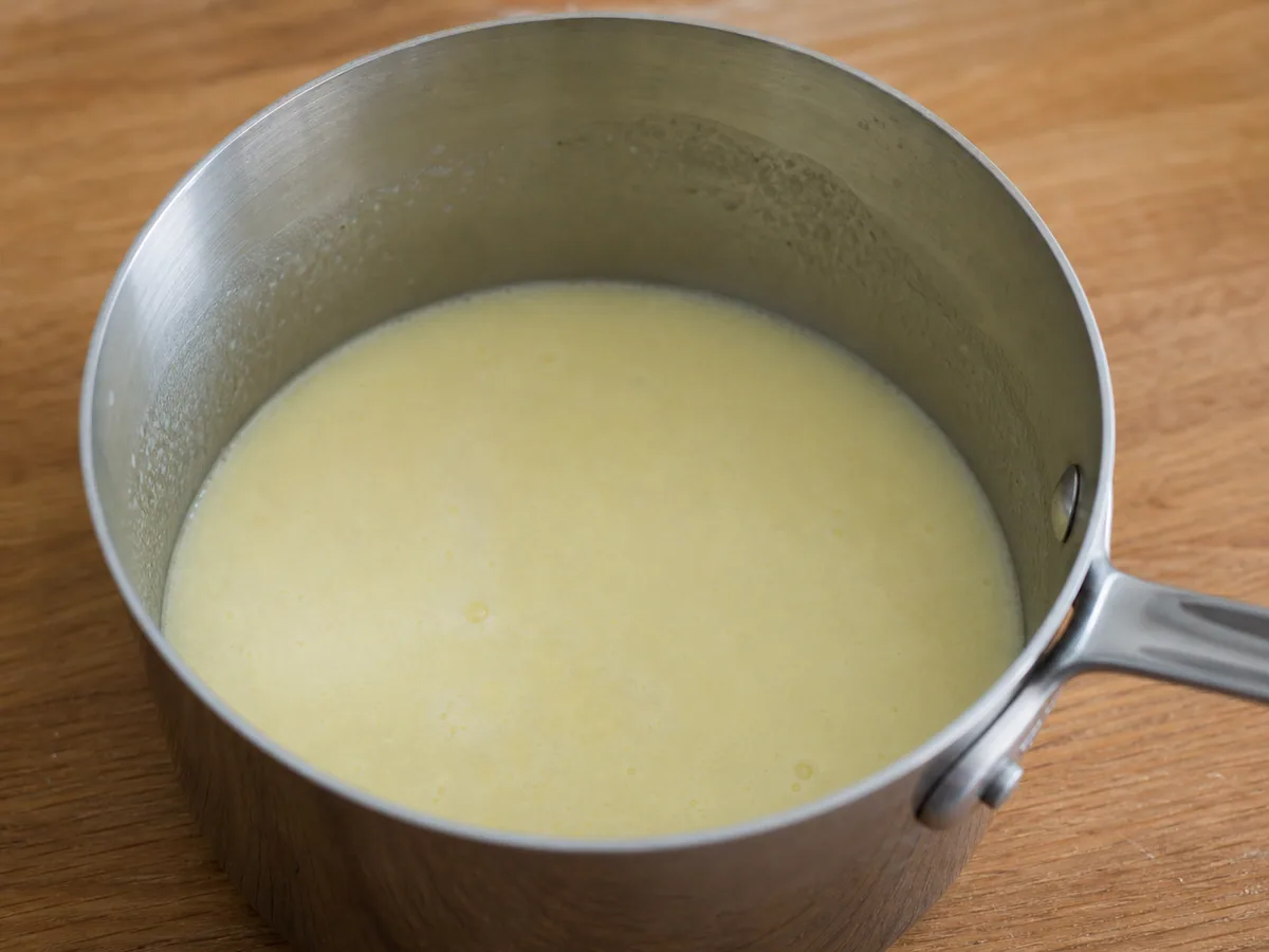 Smooth lemon posset cream just after the lemon juice is incorporated off the heat