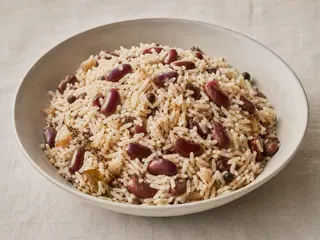 Bowl of fluffy coconut rice with red kidney beans and distinct grains