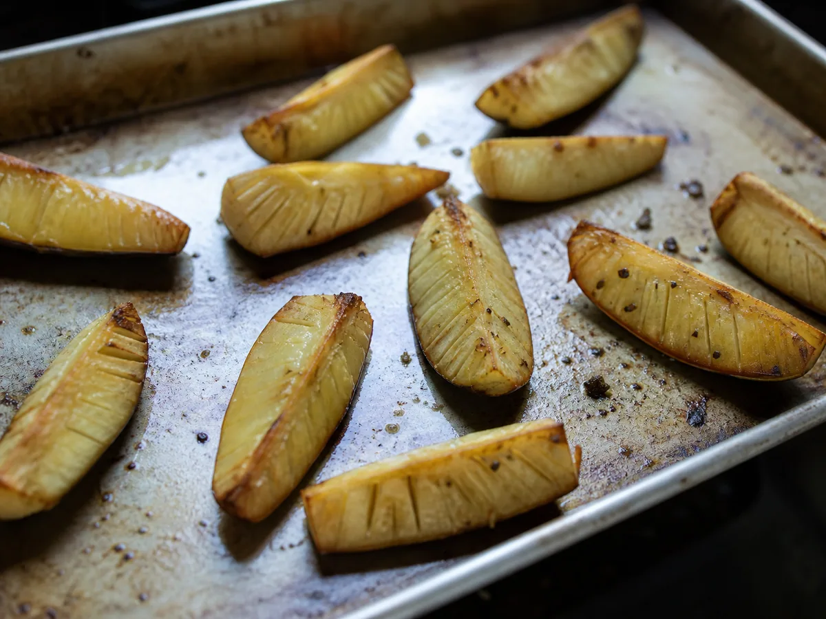 Deeply golden roasted breadfruit wedges with crisp edges and tender pale centers