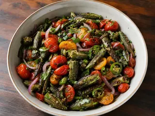 Charred okra and blistered tomato salad with red onion, cilantro, and lime
