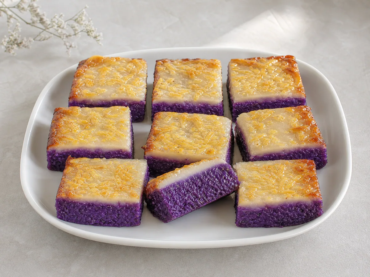 Slices of violet ube cassava cake with coconut custard and golden cheese