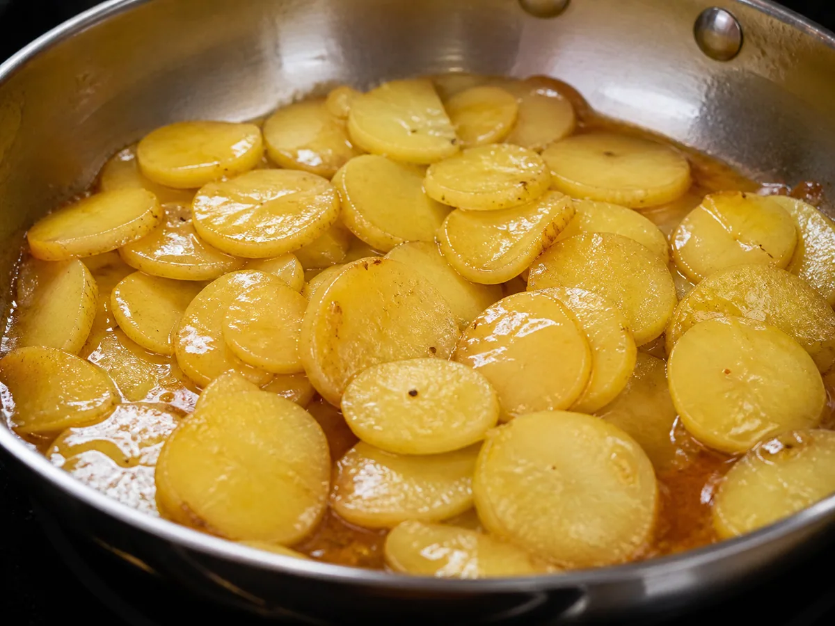 German Warm Potato Salad: Slice and dress the warm potatoes