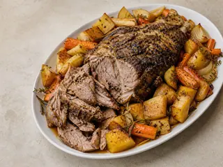 Slow-roasted lamb shoulder with browned potatoes, carrots, rutabaga, and parsnips