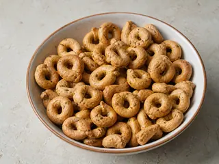 Golden Italian fennel taralli piled in a simple ceramic bowl