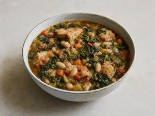 Rustic bowl of Italian ribollita with cannellini beans, cavolo nero, cabbage, and bread