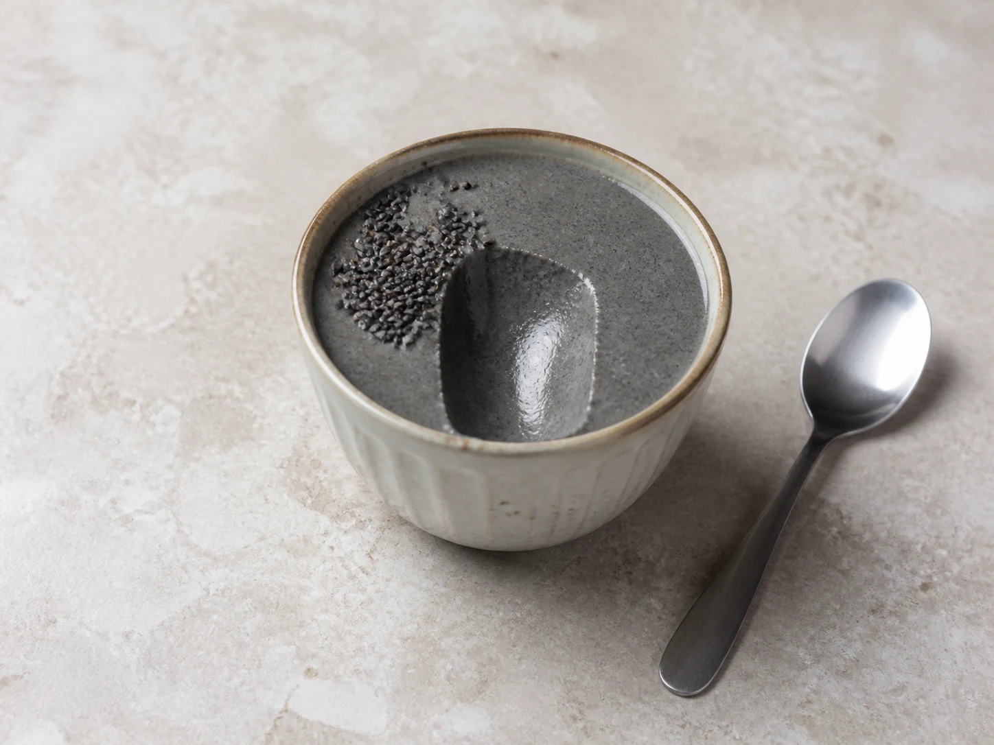 Softly set Japanese black sesame pudding with a clean spoon path in the center