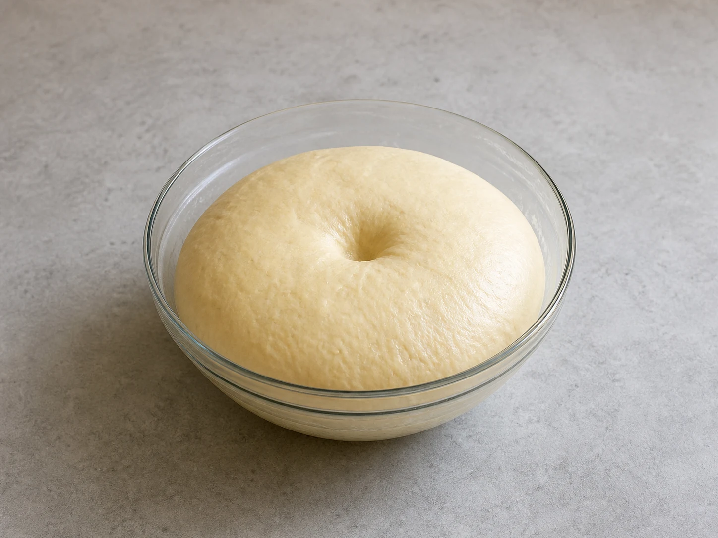 Japanese curry bread dough doubled in volume with a shallow proofing indentation