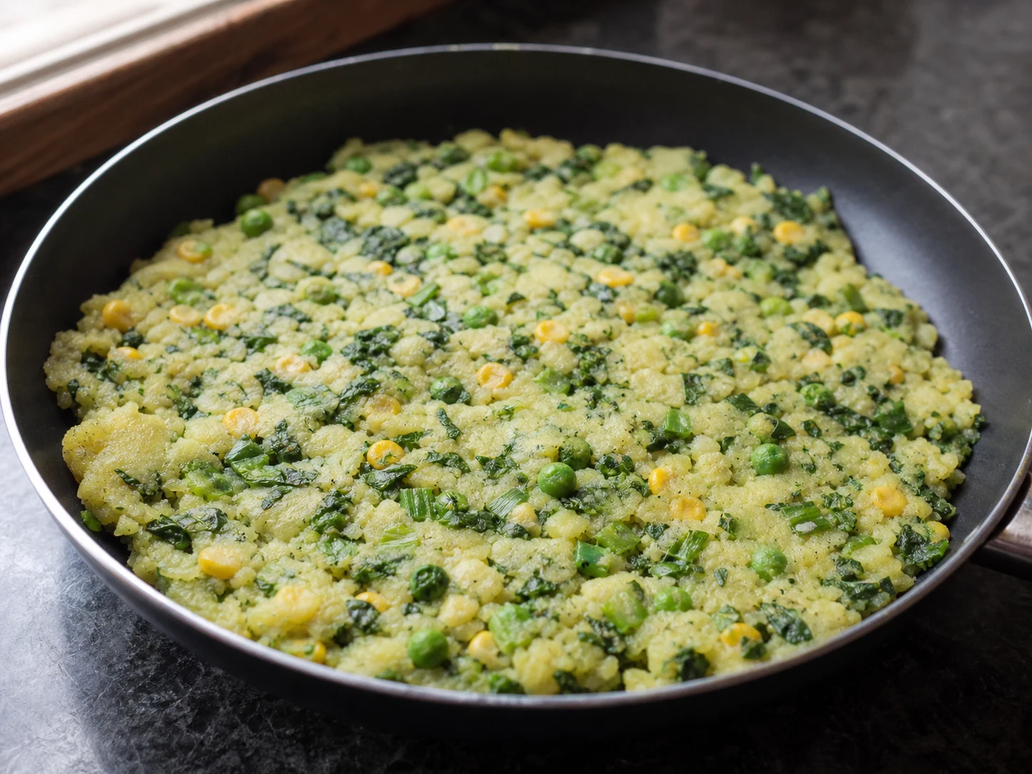 Coarse Kenyan irio mixture with whole peas and corn resting in the saucepan before shaping