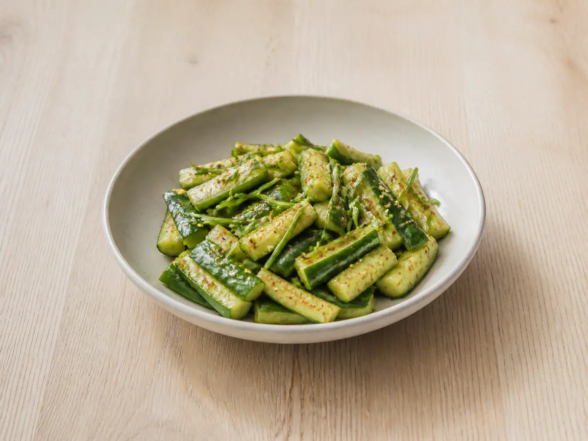 Finished Korean cucumber sesame salad in an off-white serving bowl
