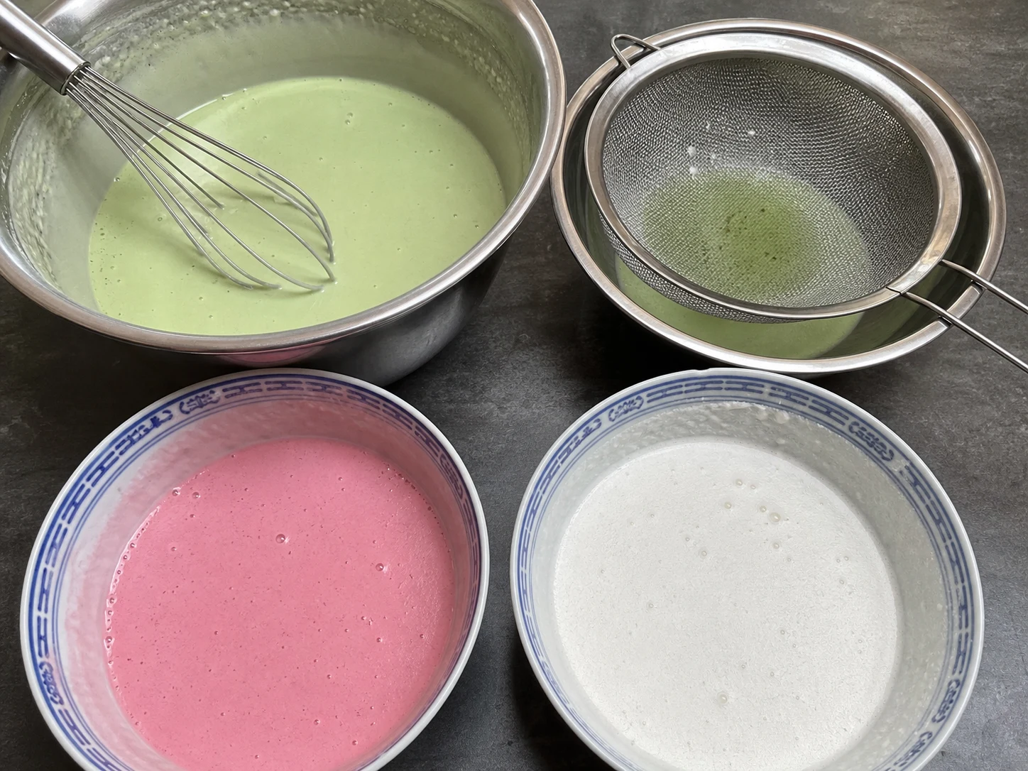 Pink and white Malaysian kuih lapis batters divided in a five-to-four ratio for nine layers