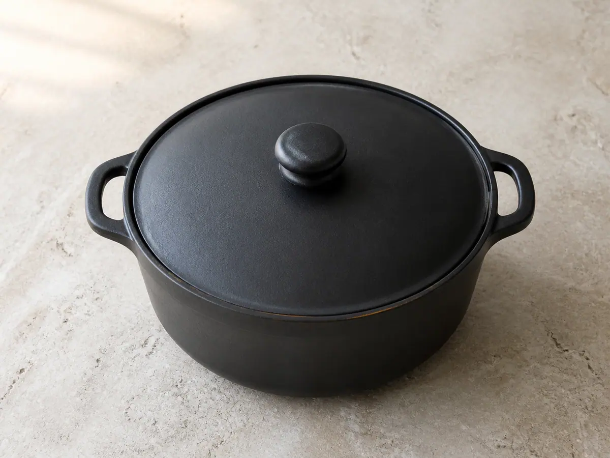 Covered heavy pot gently braising lamb in golden Moroccan spiced broth