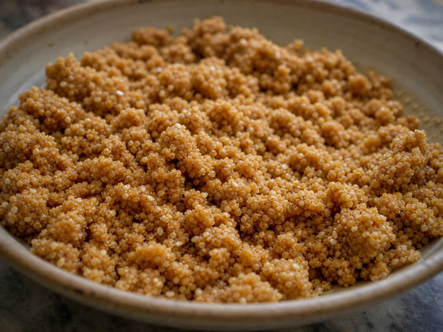 Moroccan sellou mixture with a loose sandy texture and small tender clumps in a mixing bowl