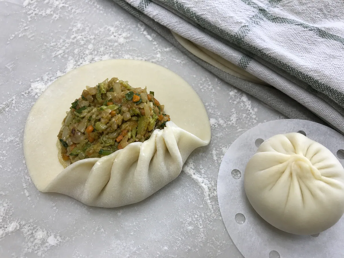 Fill and pleat the momos during preparation