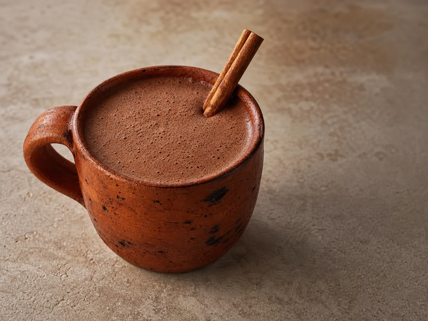 Lightly frothed Mexican cinnamon champurrado in a saucepan before serving