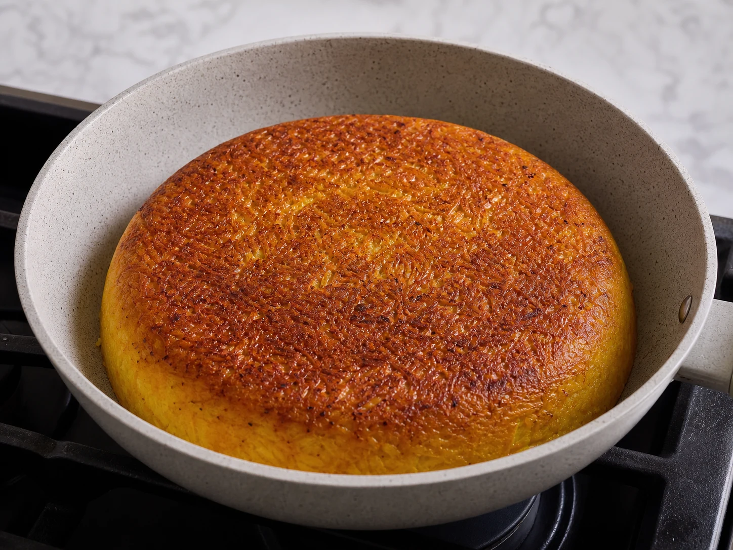 Baked tahchin with a deep golden crust visible through the glass dish