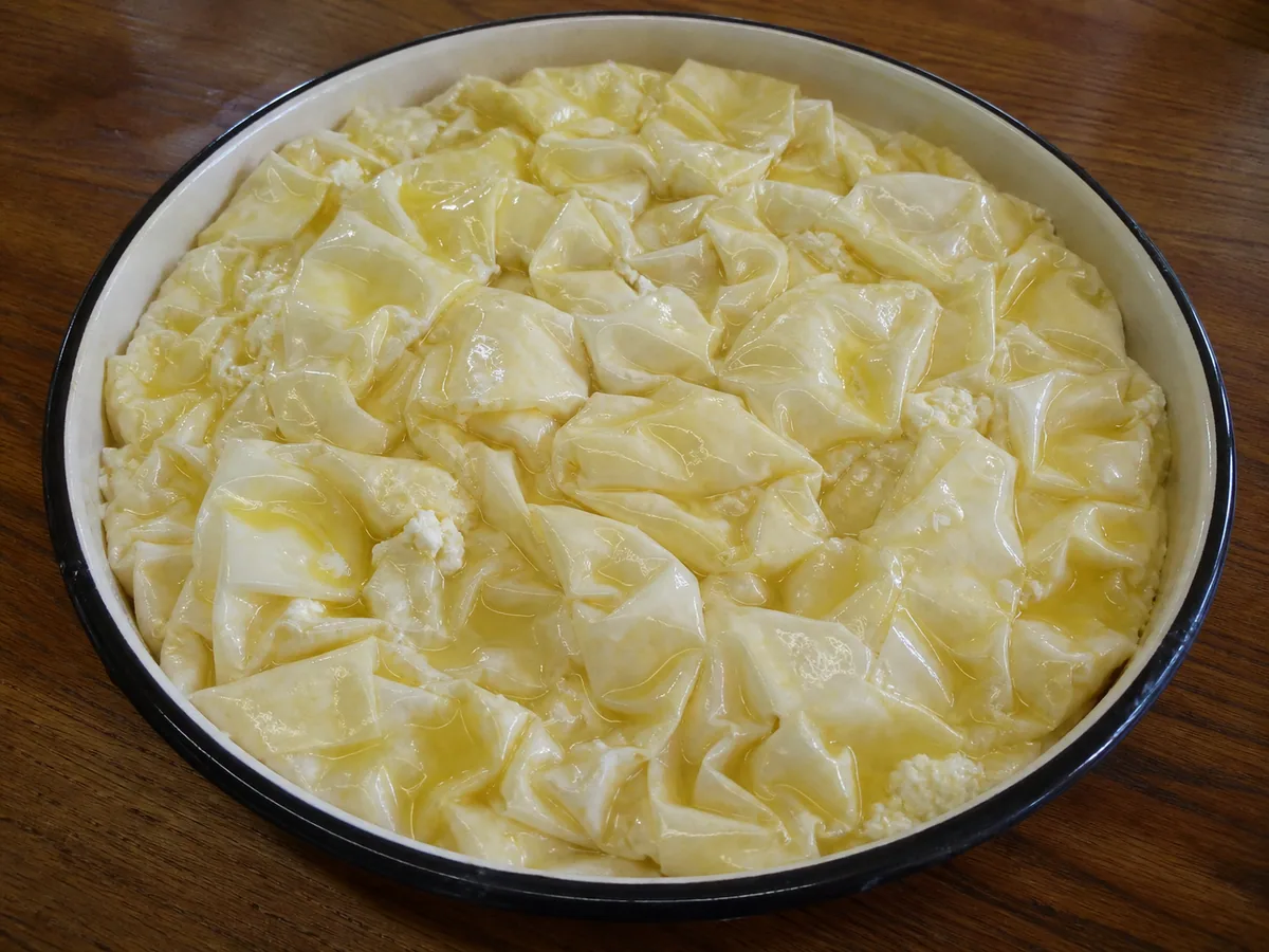 Montagem da torta com massa filo amassada durante o preparo