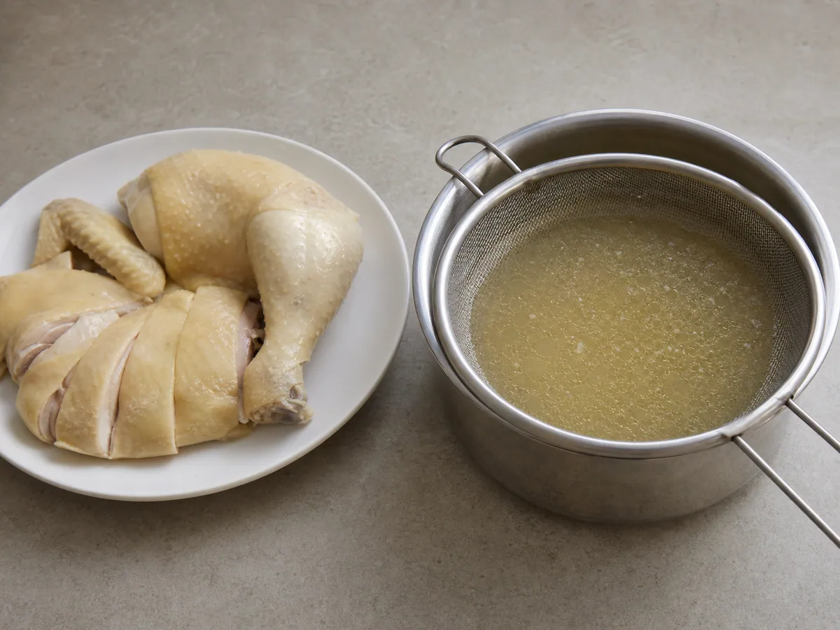 Fully cooked Hainanese pollo resting on a clean tray after its temperature check
