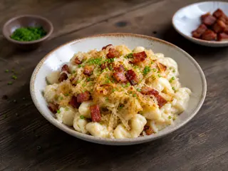 Slovak bryndza potato dumplings with browned cabbage, bacon, and chives