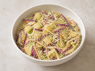 Bowl of South African cabbage and pineapple slaw with carrot and spring onion