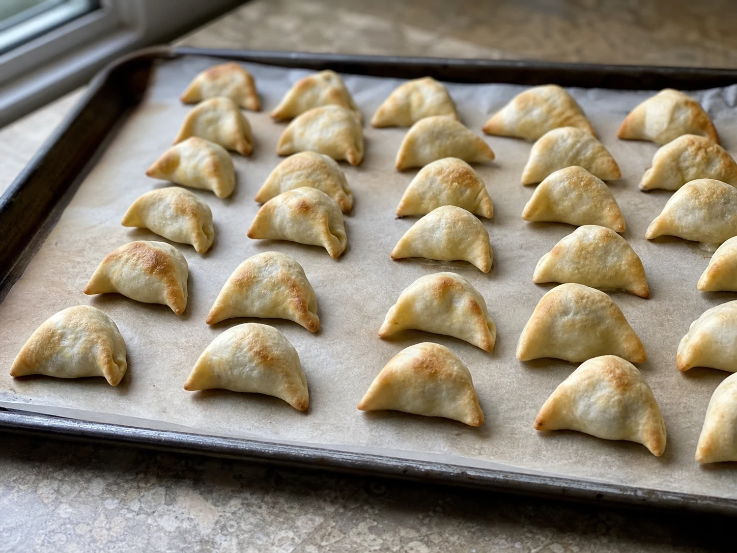 Baked shish barak dumplings with set bottoms and lightly golden edges