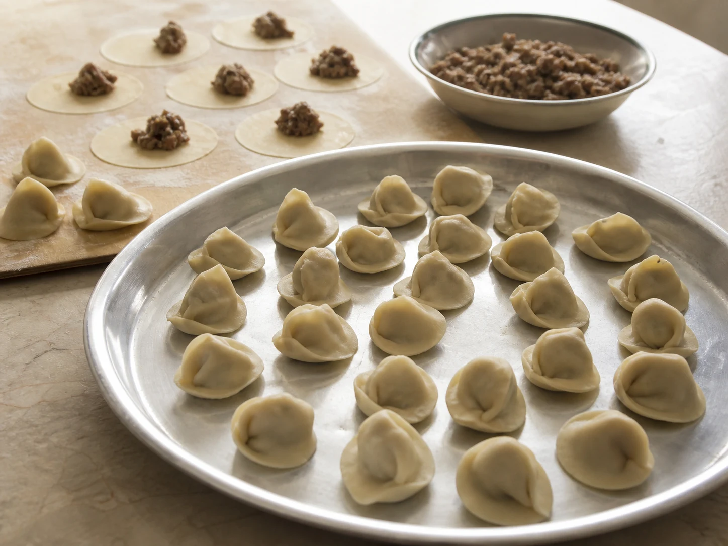 Uncooked Syrian shish barak dumplings sealed in small hat shapes