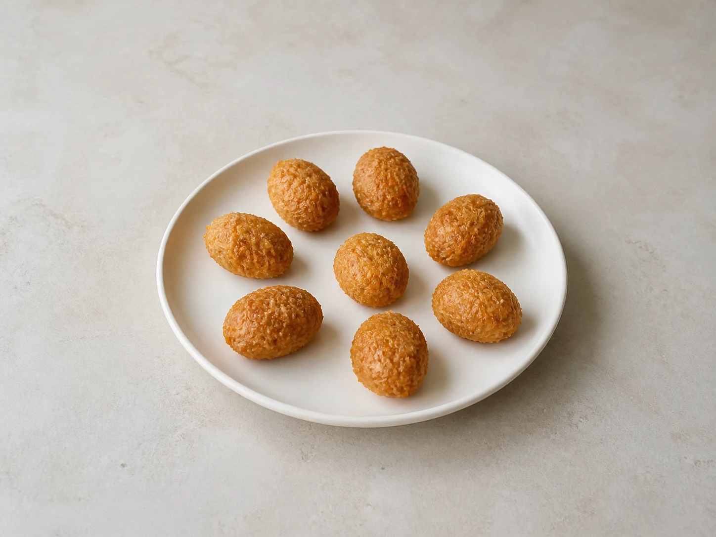 Eight equal cooled pineapple filling portions rolled into compact ovals