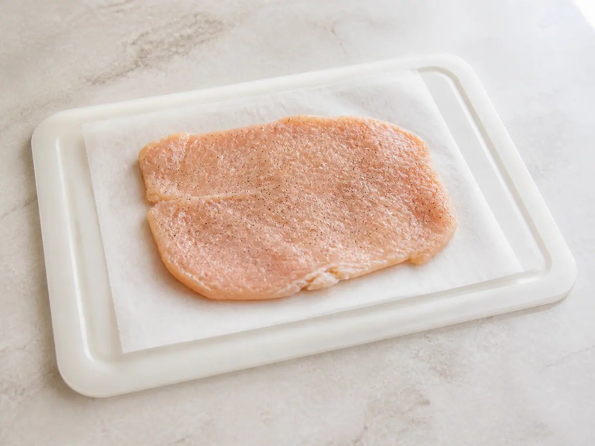 Butterflied seasoned chicken breast flattened for Chicken Kyiv