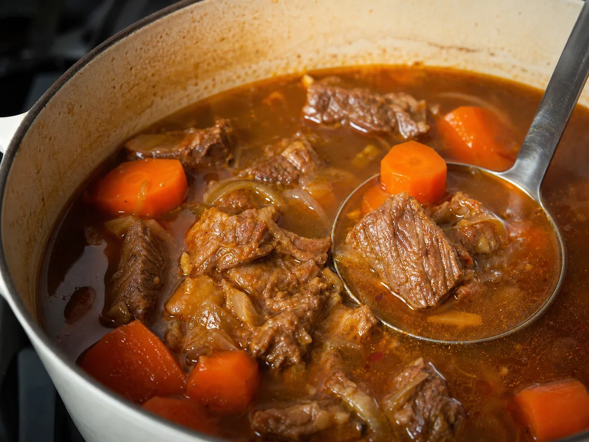 Carrots simmering with fully cooked beef in Vietnamese bò kho broth